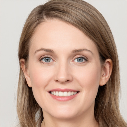 Joyful white young-adult female with long  brown hair and grey eyes