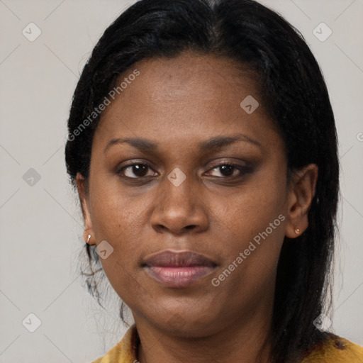 Joyful black young-adult female with long  brown hair and brown eyes