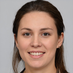 Joyful white young-adult female with medium  brown hair and brown eyes