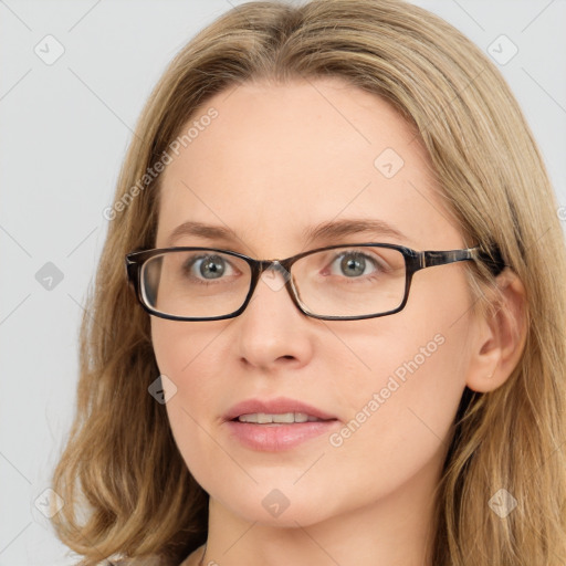 Joyful white young-adult female with long  brown hair and blue eyes