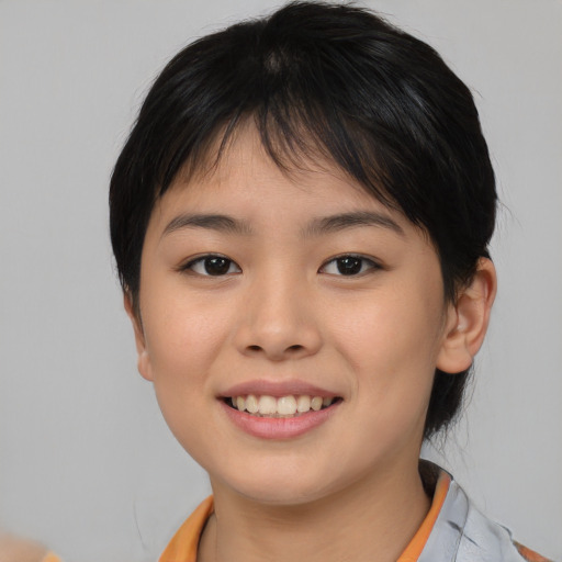 Joyful asian child female with short  brown hair and brown eyes