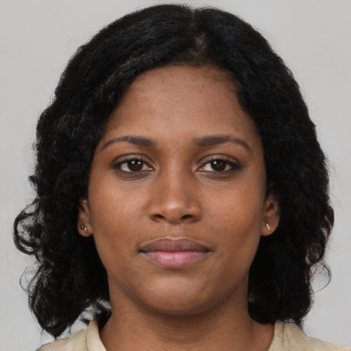 Neutral black young-adult female with long  brown hair and brown eyes