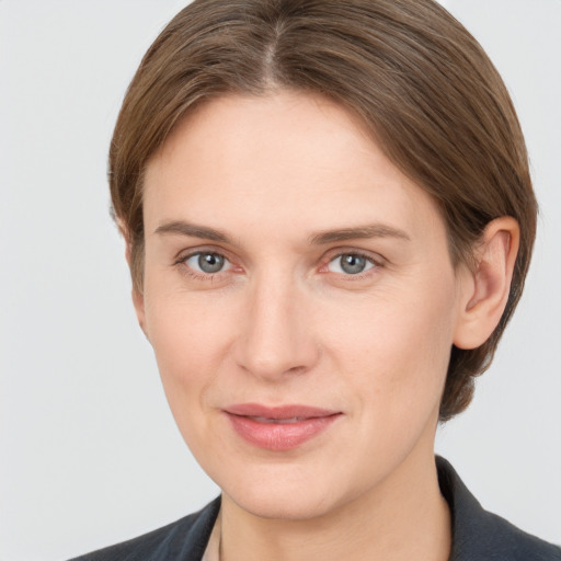 Joyful white young-adult female with short  brown hair and grey eyes