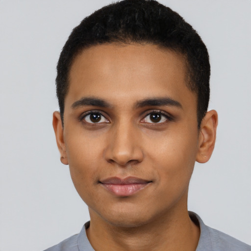 Joyful latino young-adult male with short  black hair and brown eyes