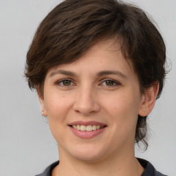 Joyful white young-adult female with medium  brown hair and grey eyes