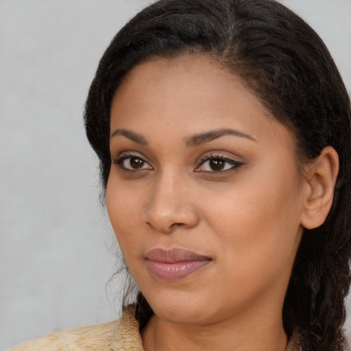 Joyful black young-adult female with medium  brown hair and brown eyes