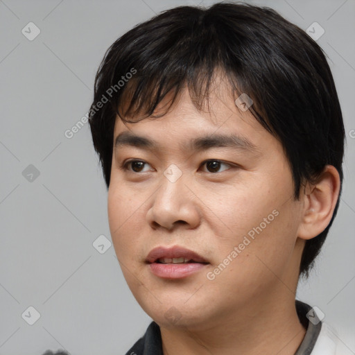 Joyful asian young-adult male with short  black hair and brown eyes