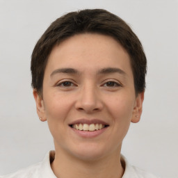 Joyful white young-adult female with short  brown hair and brown eyes