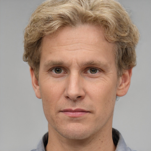 Joyful white adult male with short  brown hair and grey eyes