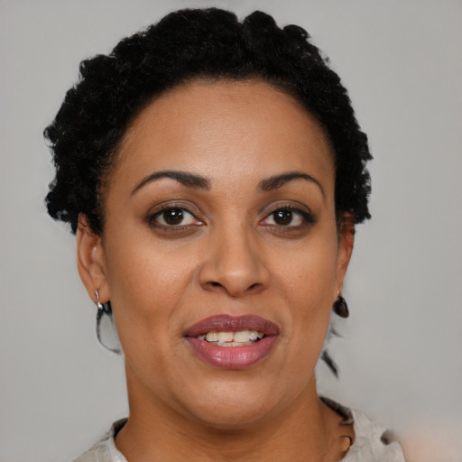 Joyful black adult female with short  brown hair and brown eyes