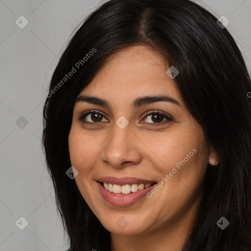 Joyful latino young-adult female with long  brown hair and brown eyes