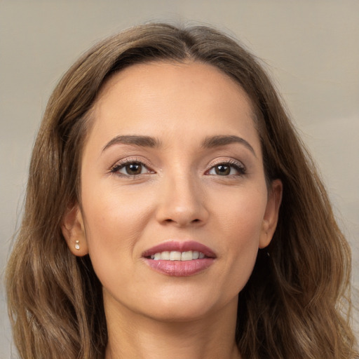 Joyful white young-adult female with long  brown hair and brown eyes