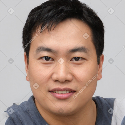 Joyful asian young-adult male with short  black hair and brown eyes