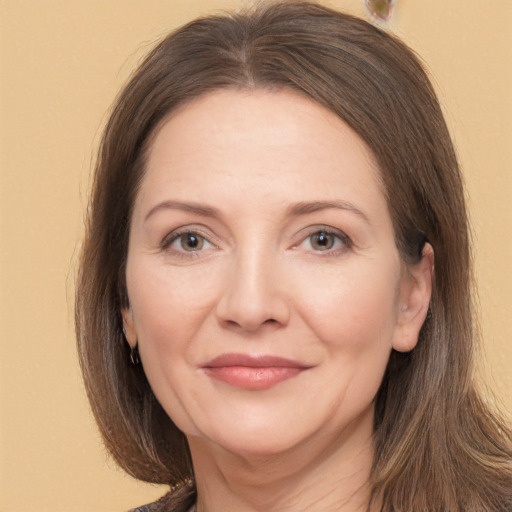 Joyful white adult female with long  brown hair and brown eyes