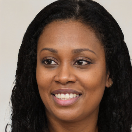 Joyful latino young-adult female with long  black hair and brown eyes
