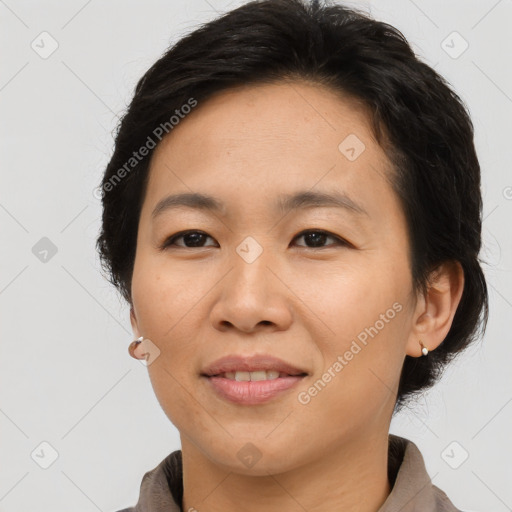 Joyful asian adult female with short  brown hair and brown eyes