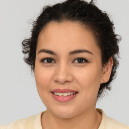 Joyful latino young-adult female with medium  brown hair and brown eyes