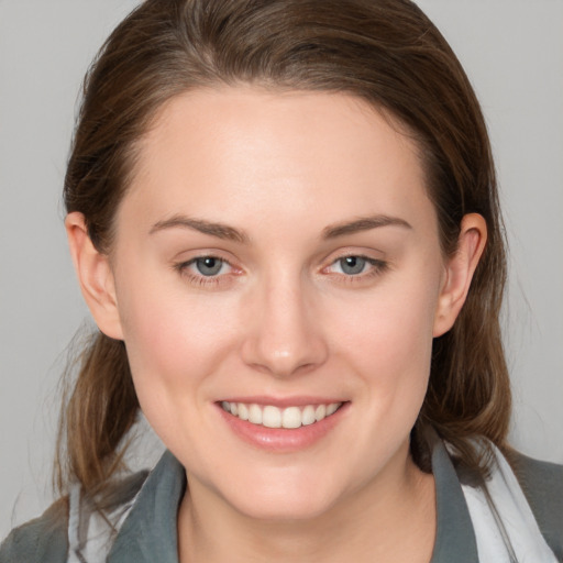 Joyful white young-adult female with medium  brown hair and blue eyes