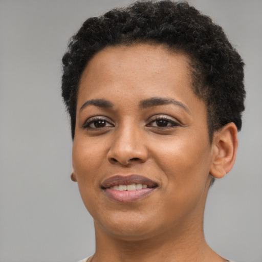 Joyful black young-adult female with short  brown hair and brown eyes