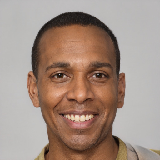Joyful latino adult male with short  black hair and brown eyes