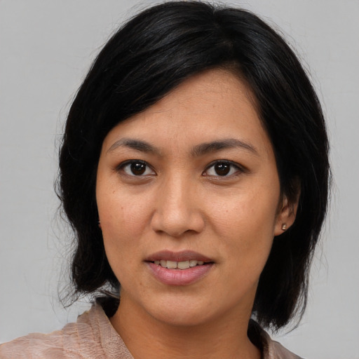 Joyful latino young-adult female with medium  black hair and brown eyes