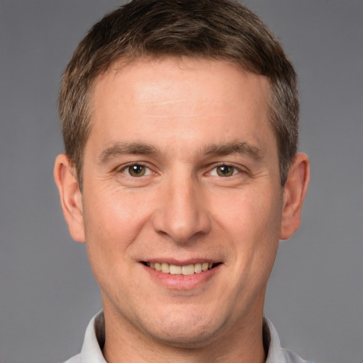 Joyful white adult male with short  brown hair and brown eyes