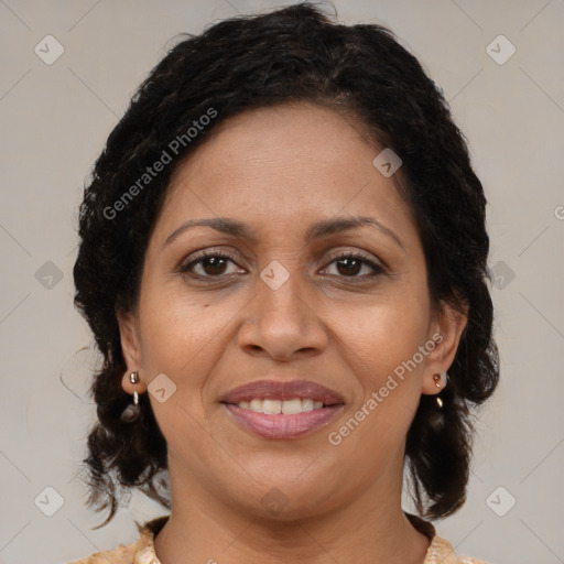 Joyful latino adult female with medium  brown hair and brown eyes