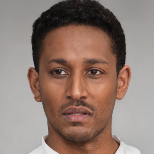 Neutral latino young-adult male with short  black hair and brown eyes