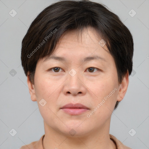 Joyful asian adult male with short  brown hair and brown eyes