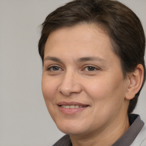 Joyful white adult female with short  brown hair and brown eyes