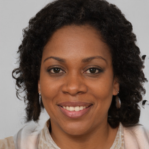 Joyful black young-adult female with medium  brown hair and brown eyes