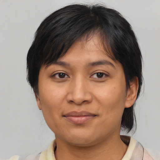 Joyful asian adult female with medium  brown hair and brown eyes