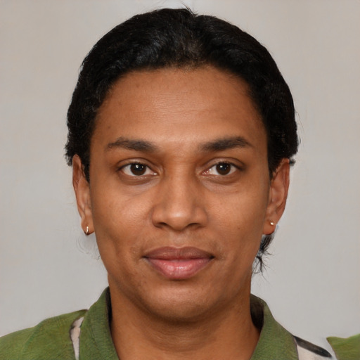 Joyful black adult female with short  black hair and brown eyes