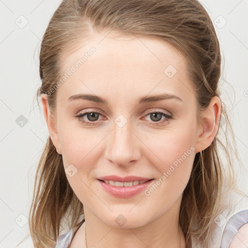 Joyful white young-adult female with medium  brown hair and blue eyes