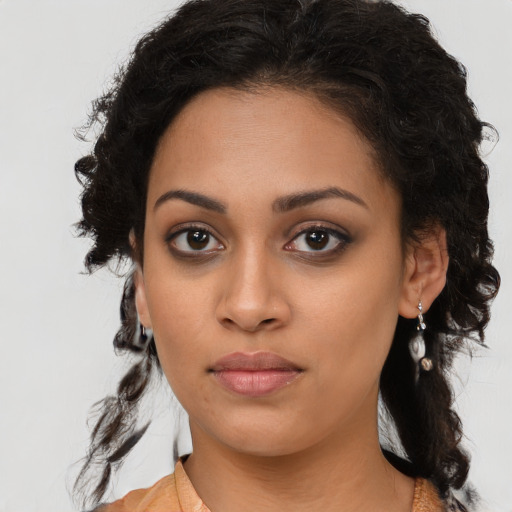 Joyful latino young-adult female with long  brown hair and brown eyes