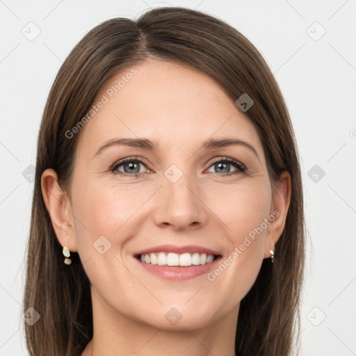 Joyful white young-adult female with long  brown hair and grey eyes