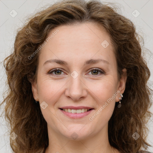 Joyful white adult female with long  brown hair and brown eyes