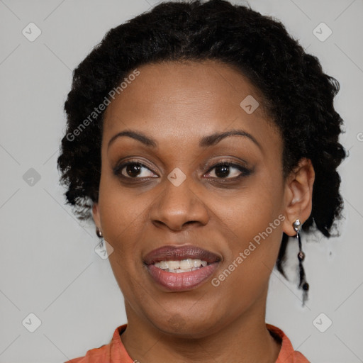 Joyful black adult female with medium  brown hair and brown eyes