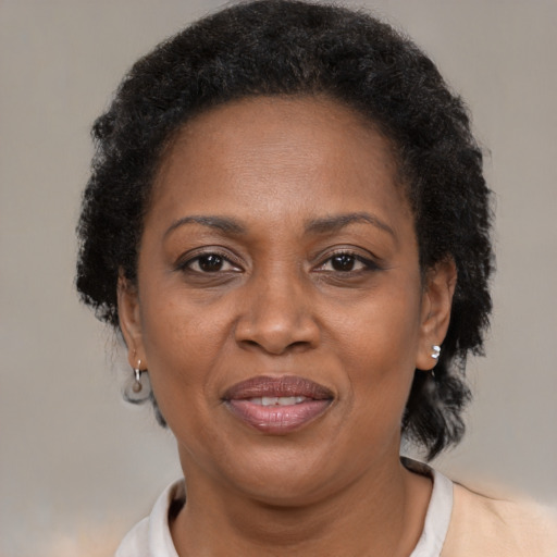 Joyful black adult female with short  brown hair and brown eyes