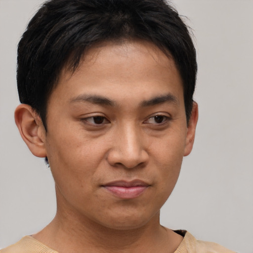 Joyful asian young-adult male with short  brown hair and brown eyes