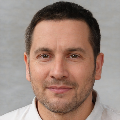 Joyful white adult male with short  brown hair and brown eyes