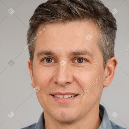 Joyful white adult male with short  brown hair and brown eyes