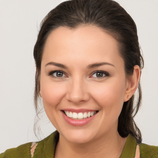 Joyful white young-adult female with medium  brown hair and brown eyes