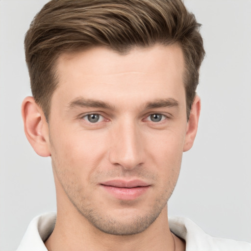 Joyful white young-adult male with short  brown hair and grey eyes