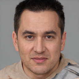 Joyful white adult male with short  brown hair and brown eyes