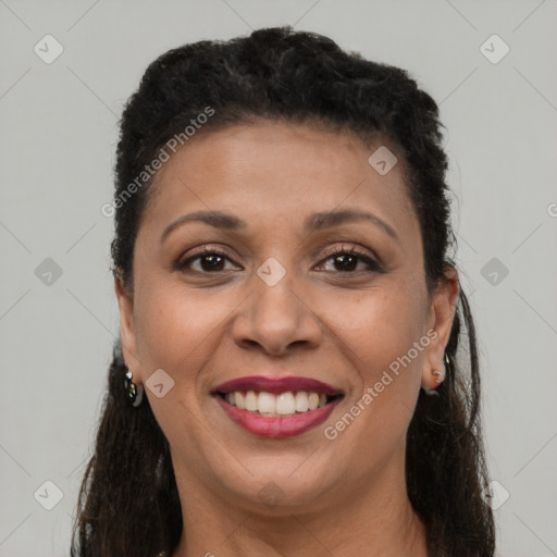 Joyful black young-adult female with long  brown hair and brown eyes