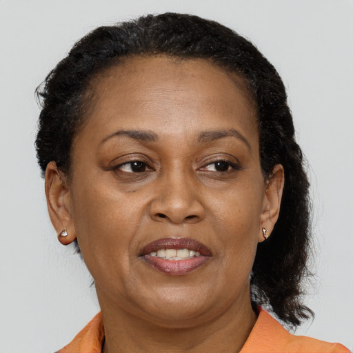 Joyful black adult female with medium  brown hair and brown eyes