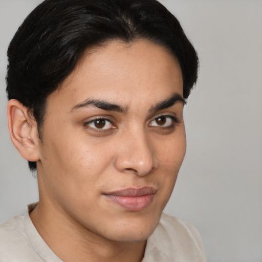 Joyful latino young-adult male with short  brown hair and brown eyes