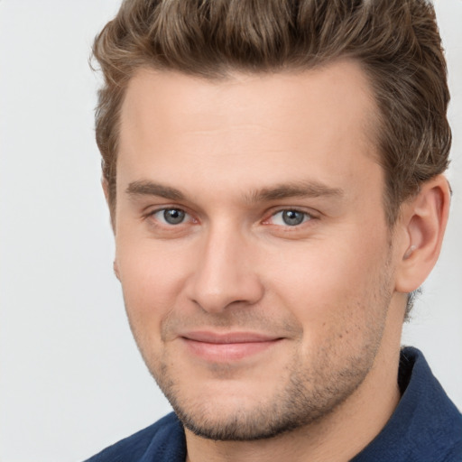 Joyful white young-adult male with short  brown hair and brown eyes