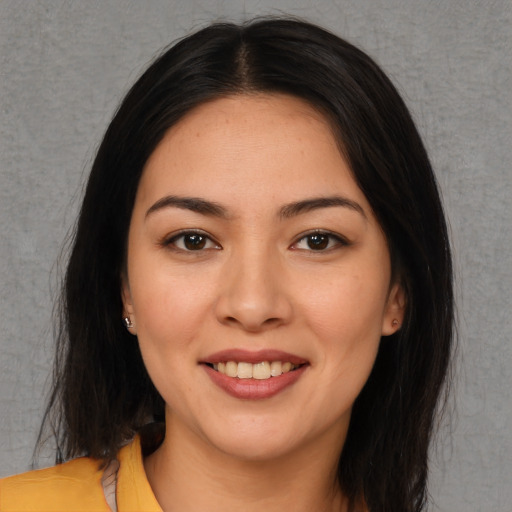 Joyful asian young-adult female with long  brown hair and brown eyes